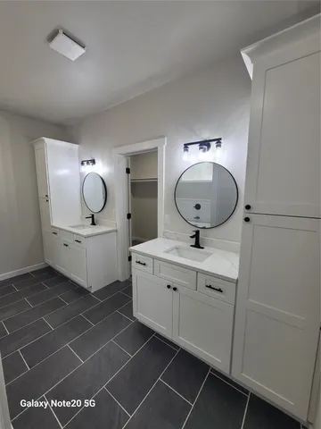 a bathroom with a sink mirror and vanity