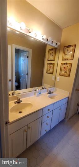 6399 True Lane Springfield, VA 22150 - Photo 5 of 5 a bathroom with a granite countertop sink and a mirror
