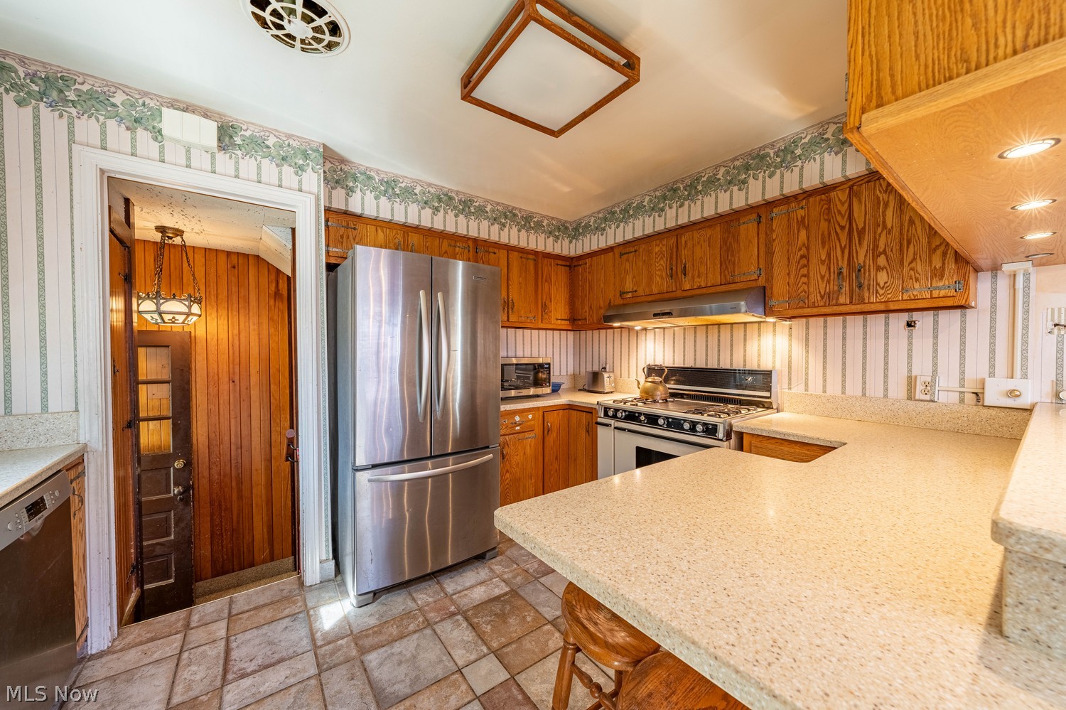 19675 Henry Road Cleveland, OH 44126 - Photo 14 of 42 Kitchen featuring ceramic tile floors, Corian counters, and ample cabinet space