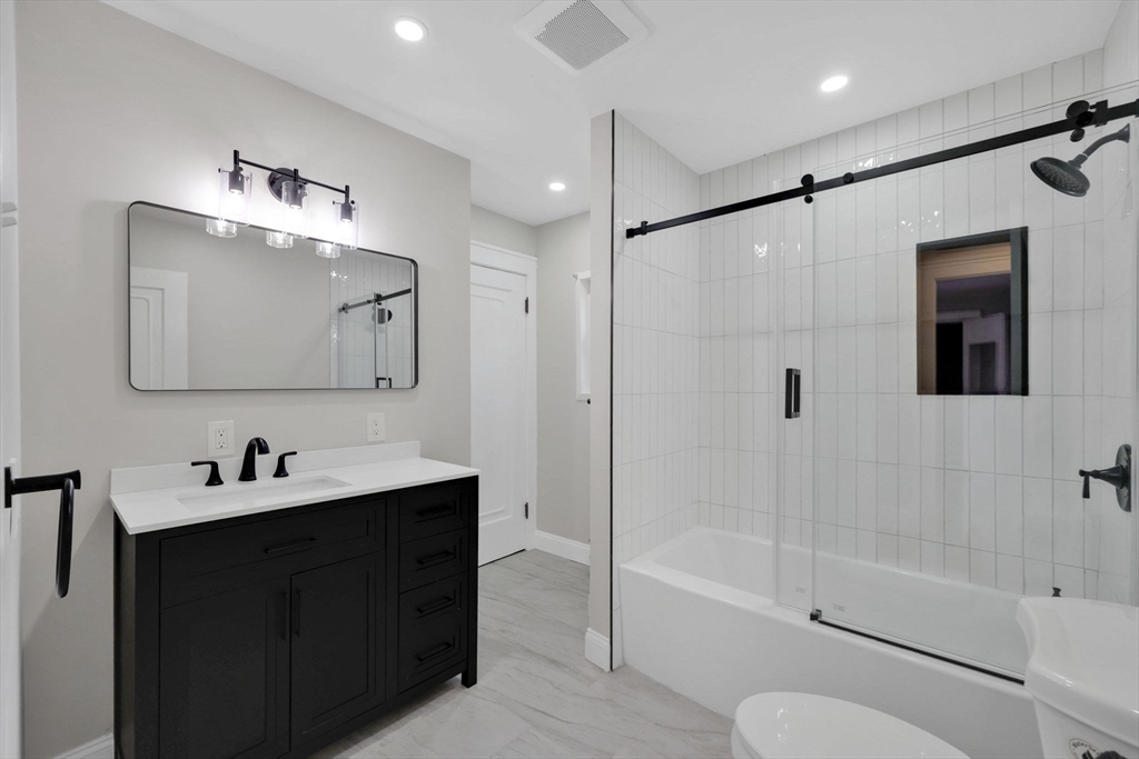 92 Grove Street West Springfield, MA 01089 - Photo 25 of 41 a bathroom with a tub sink toilet and a mirror