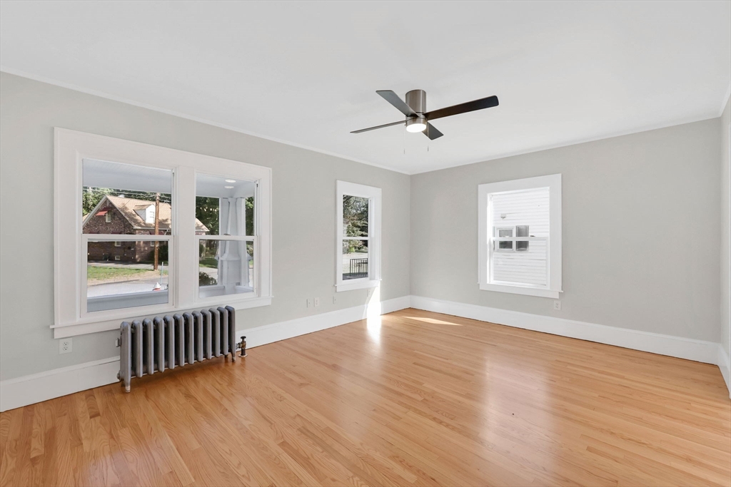 92 Grove Street West Springfield, MA 01089 - Photo 10 of 41 a view of an empty room with a window and wooden floor