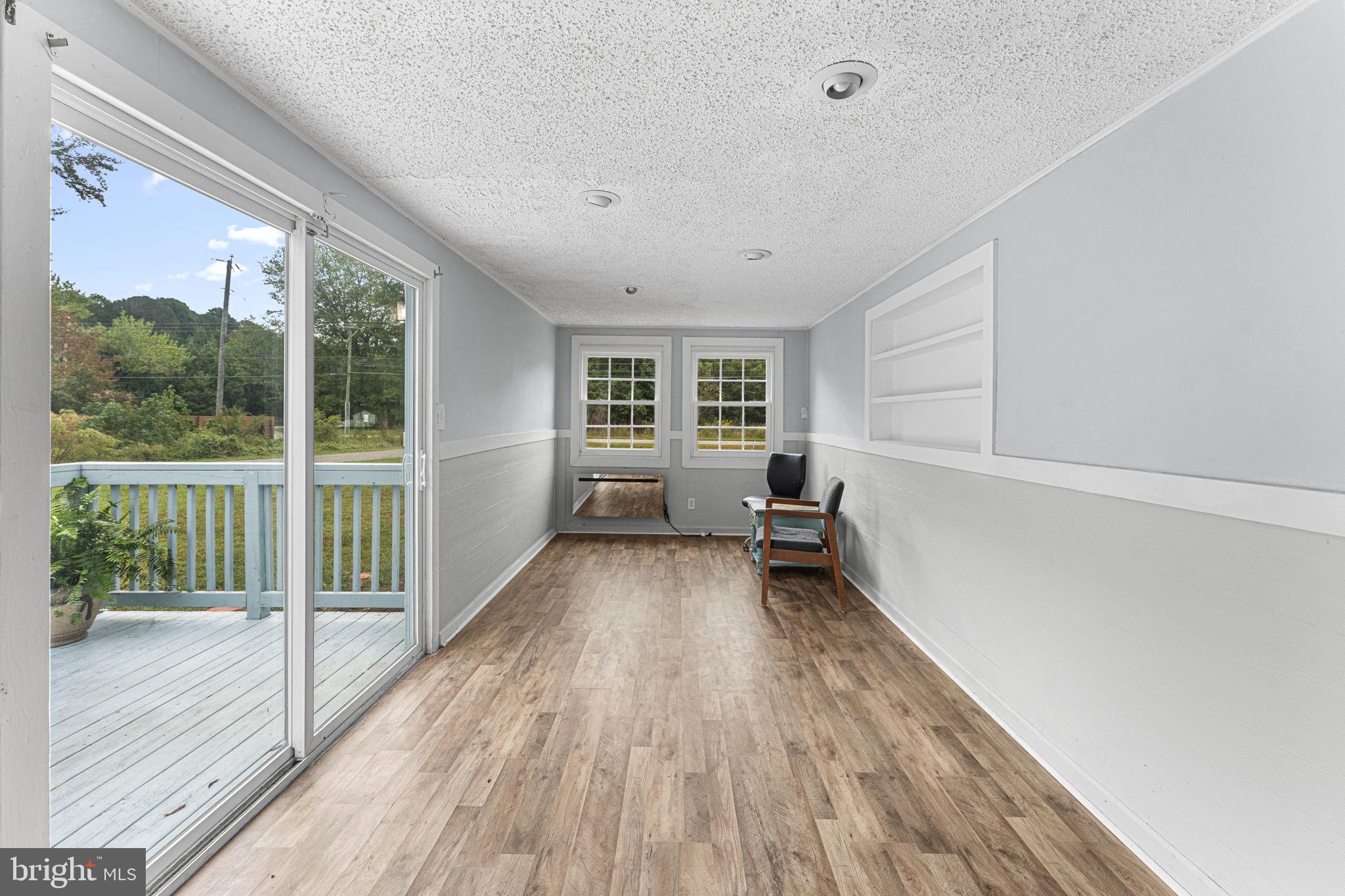 1678 Weems Road Weems, VA 22576 - Photo 11 of 30 a view of empty room with wooden floor and fan