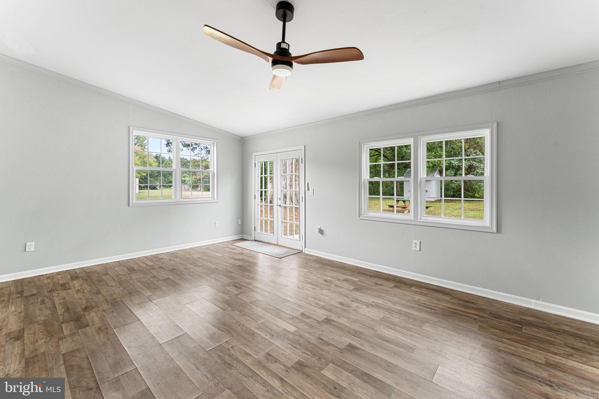 1678 Weems Road Weems, VA 22576 - Photo 14 of 30 a view of an empty room with window and wooden floor