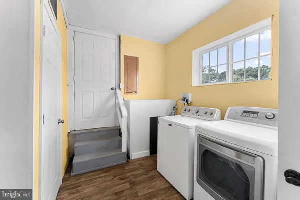 a view of washer and dryer with kitchen in the room