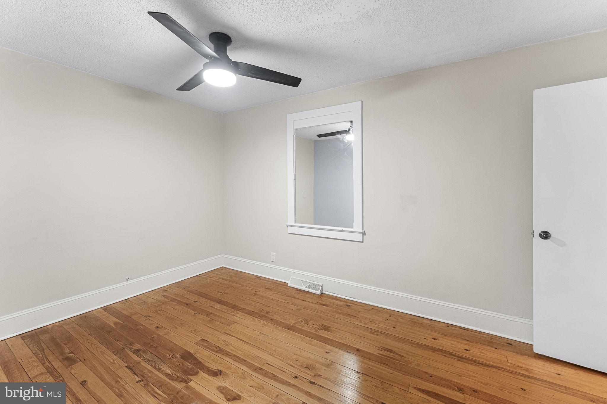 1678 Weems Road Weems, VA 22576 - Photo 18 of 30 a view of a big room with wooden floor and a ceiling fan