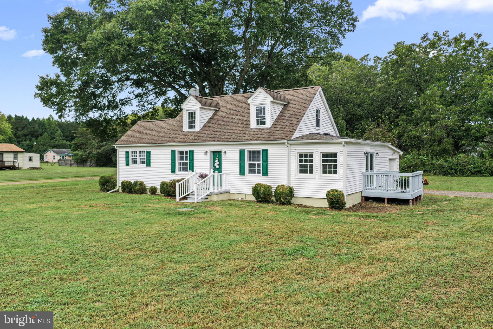 1678 Weems Road Weems, VA 22576 - Photo 2 of 30 a front view of a house with a garden