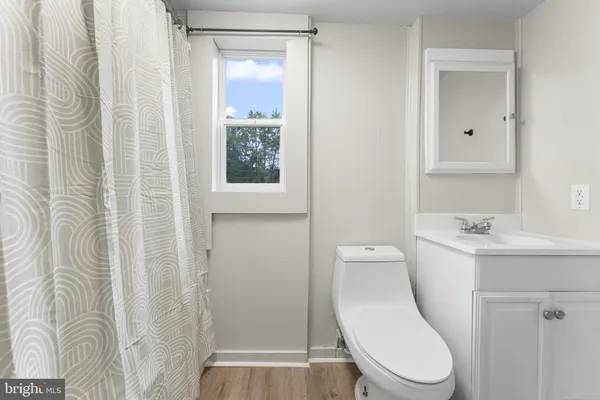 a white toilet sitting next to a bathroom sink