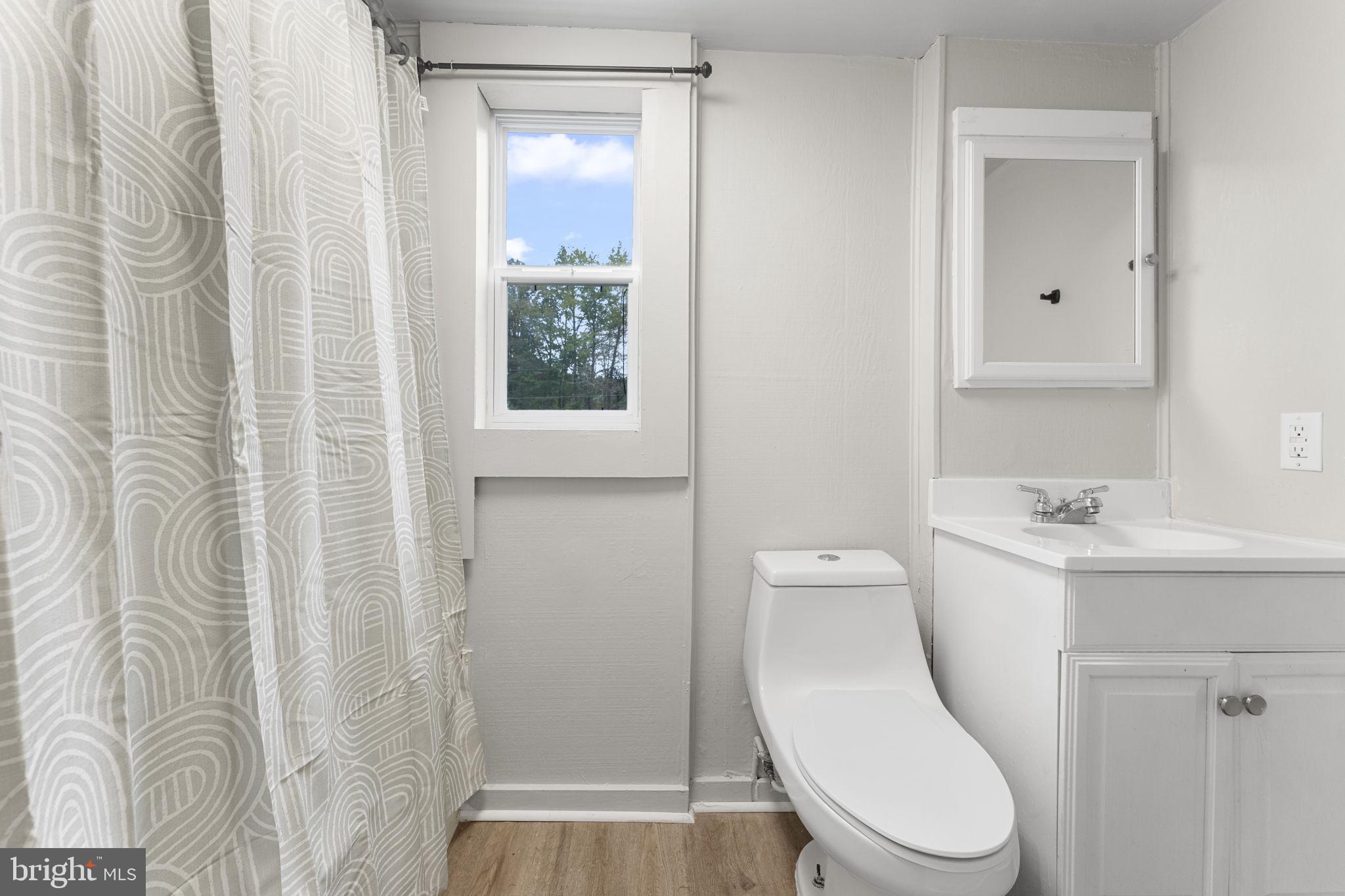 1678 Weems Road Weems, VA 22576 - Photo 23 of 30 a white toilet sitting next to a bathroom sink