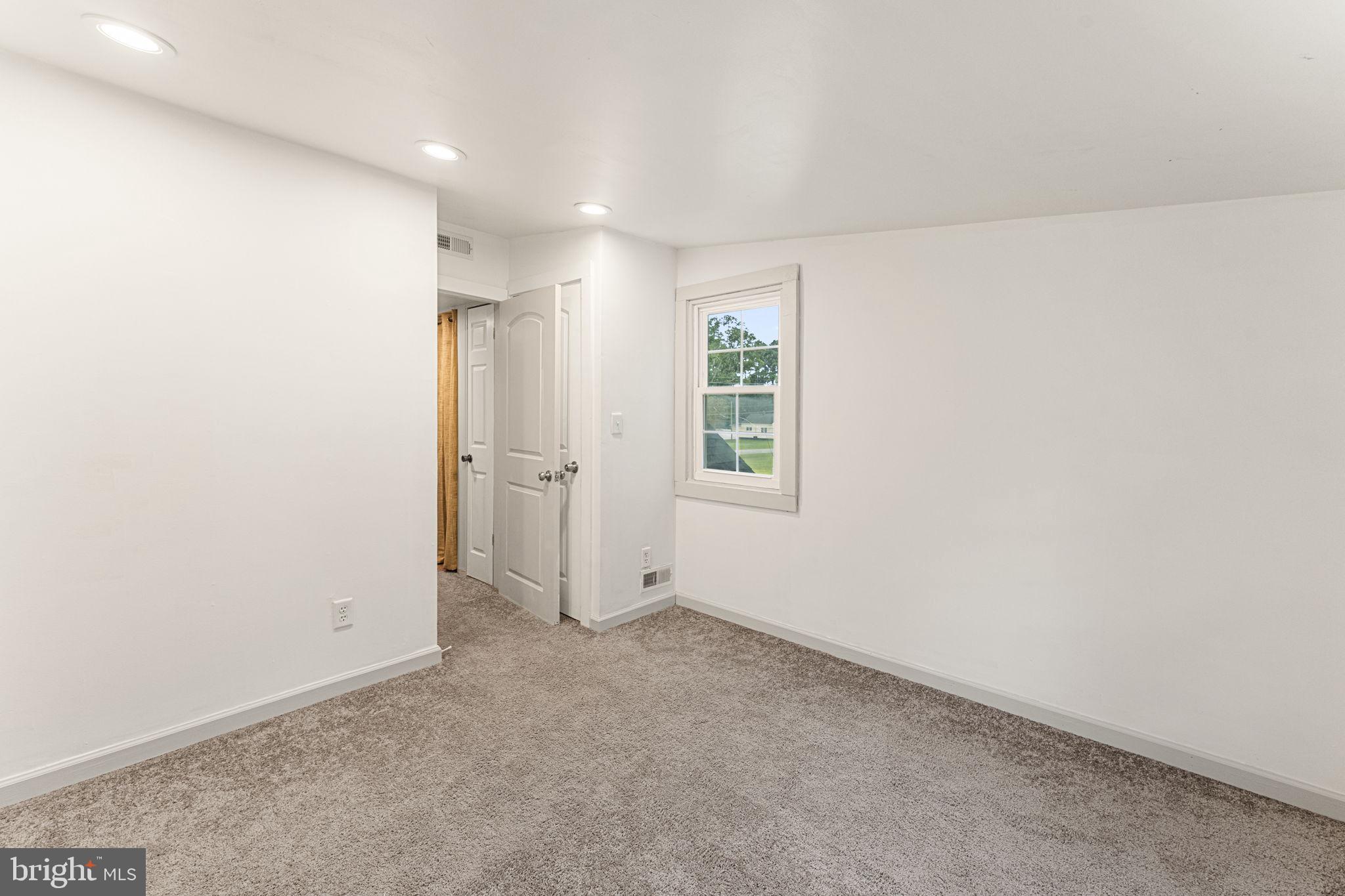 1678 Weems Road Weems, VA 22576 - Photo 25 of 30 an empty room with windows and closet