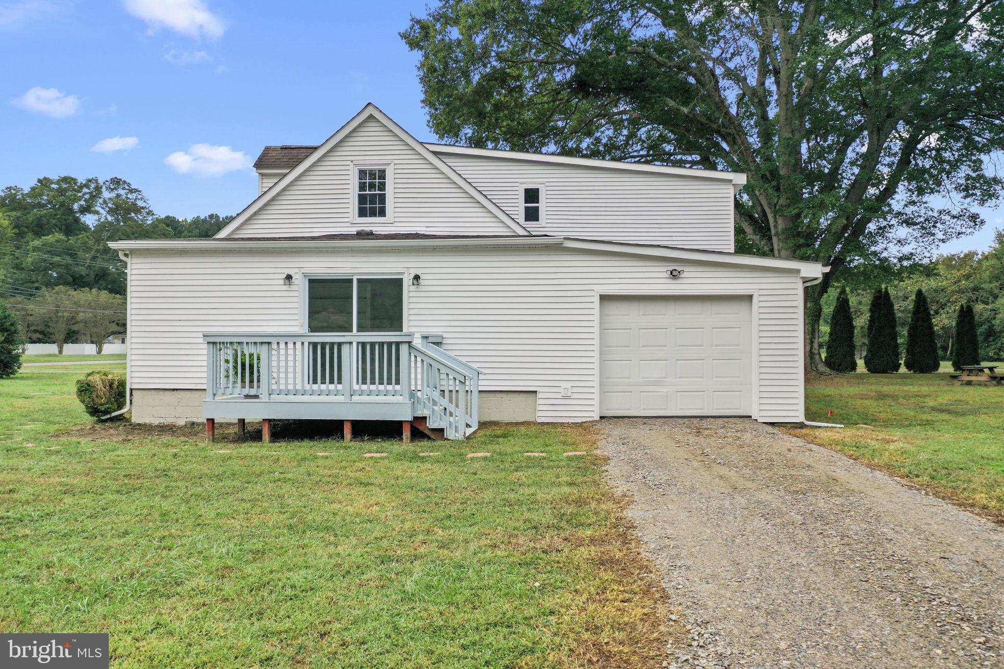 1678 Weems Road Weems, VA 22576 - Photo 27 of 30 a front view of a house with a garden