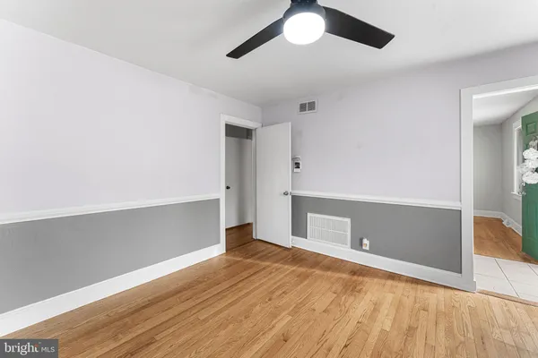a view of empty room with wooden floor