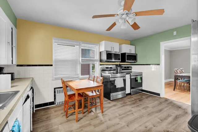 a kitchen with a stove a sink and a refrigerator