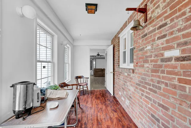 a view of a living room with furniture and wooden floor