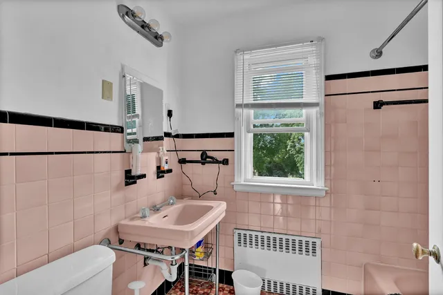 a bathroom with a sink toilet a mirror and shower