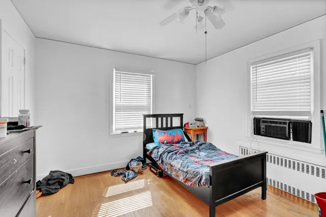 a bedroom with a bed and dresser