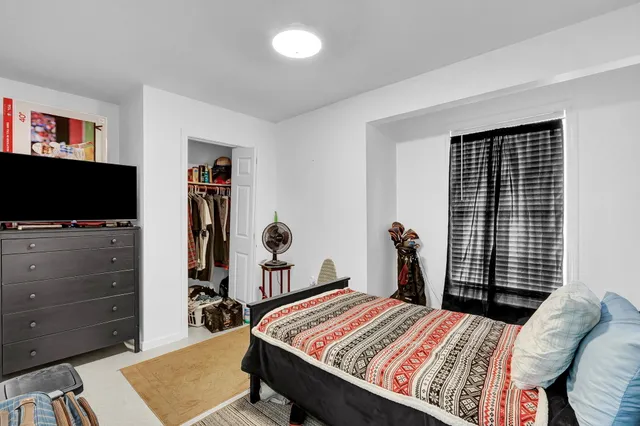 a bed room with a bed and a television