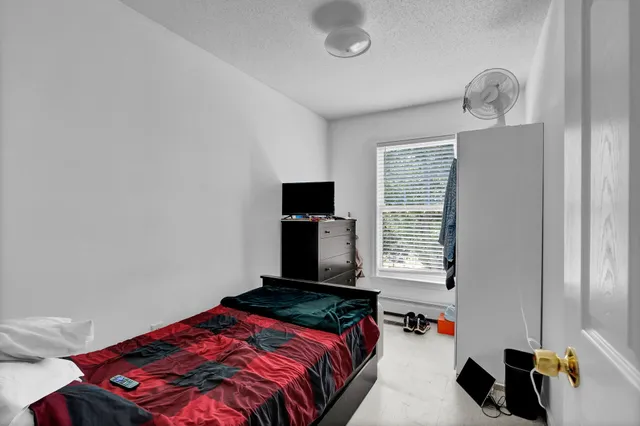 a bedroom with a bed and a window