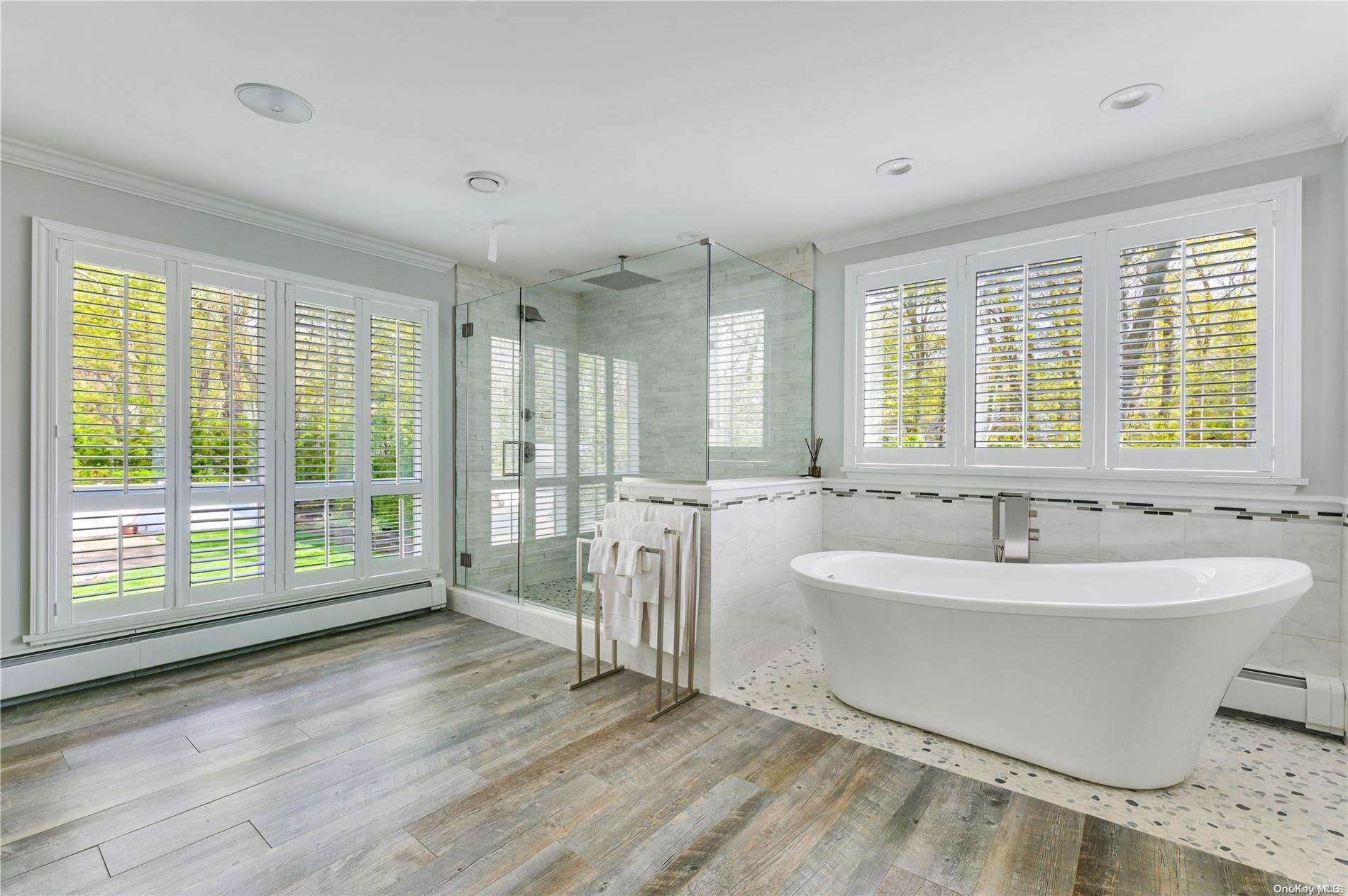 355 Windjammer Drive Southold, NY 11971 - Photo 15 of 21 a spacious bathroom with a double vanity sink and a bathtub