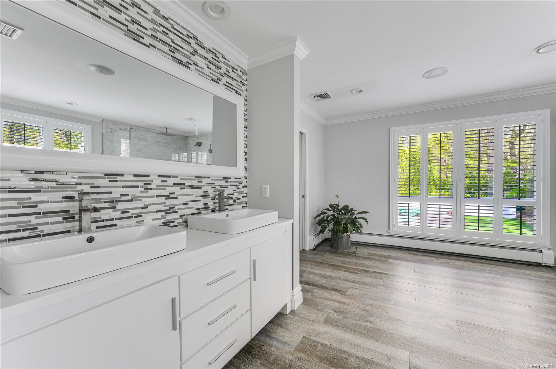 355 Windjammer Drive Southold, NY 11971 - Photo 16 of 21 a bathroom with a double vanity sink and a large mirror