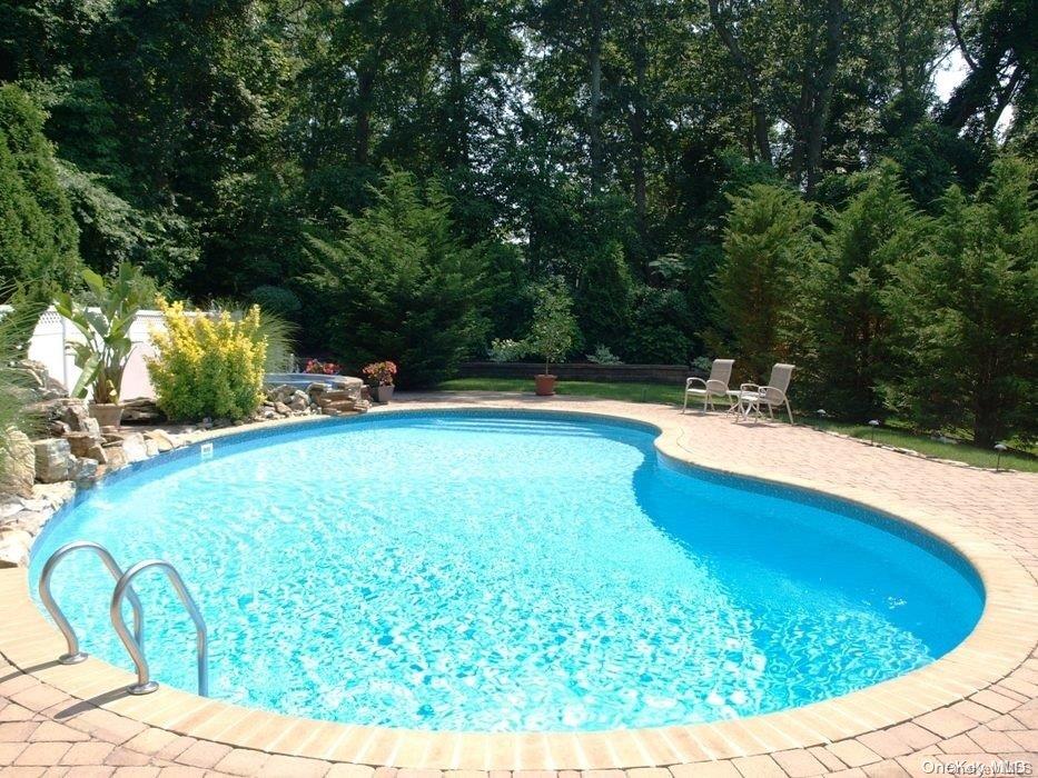355 Windjammer Drive Southold, NY 11971 - Photo 2 of 21 a view of a swimming pool with an outdoor seating