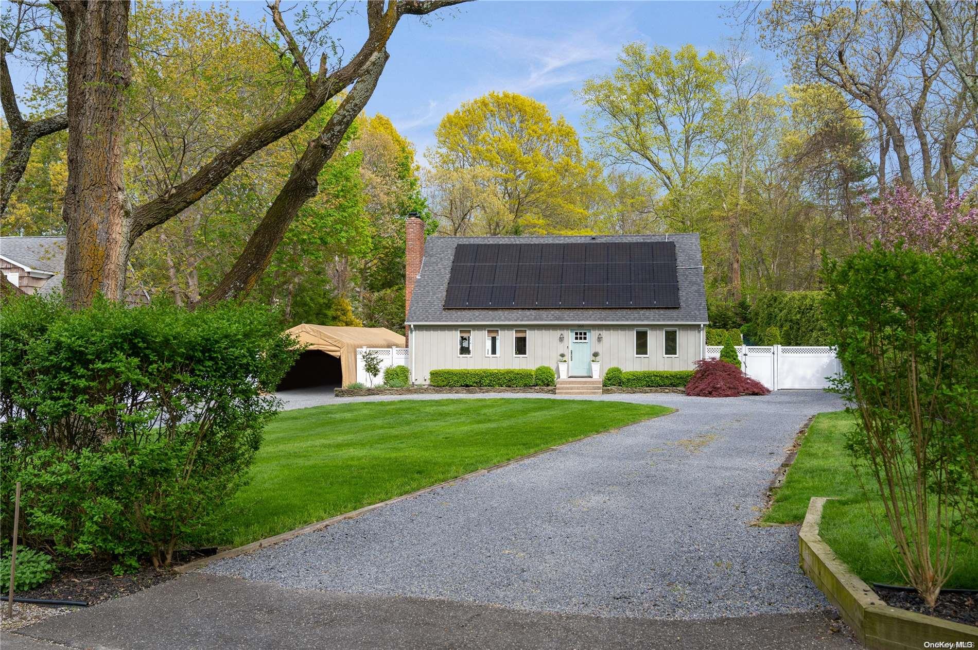 355 Windjammer Drive Southold, NY 11971 - Photo 21 of 21 a view of a house with a yard and hanging chair