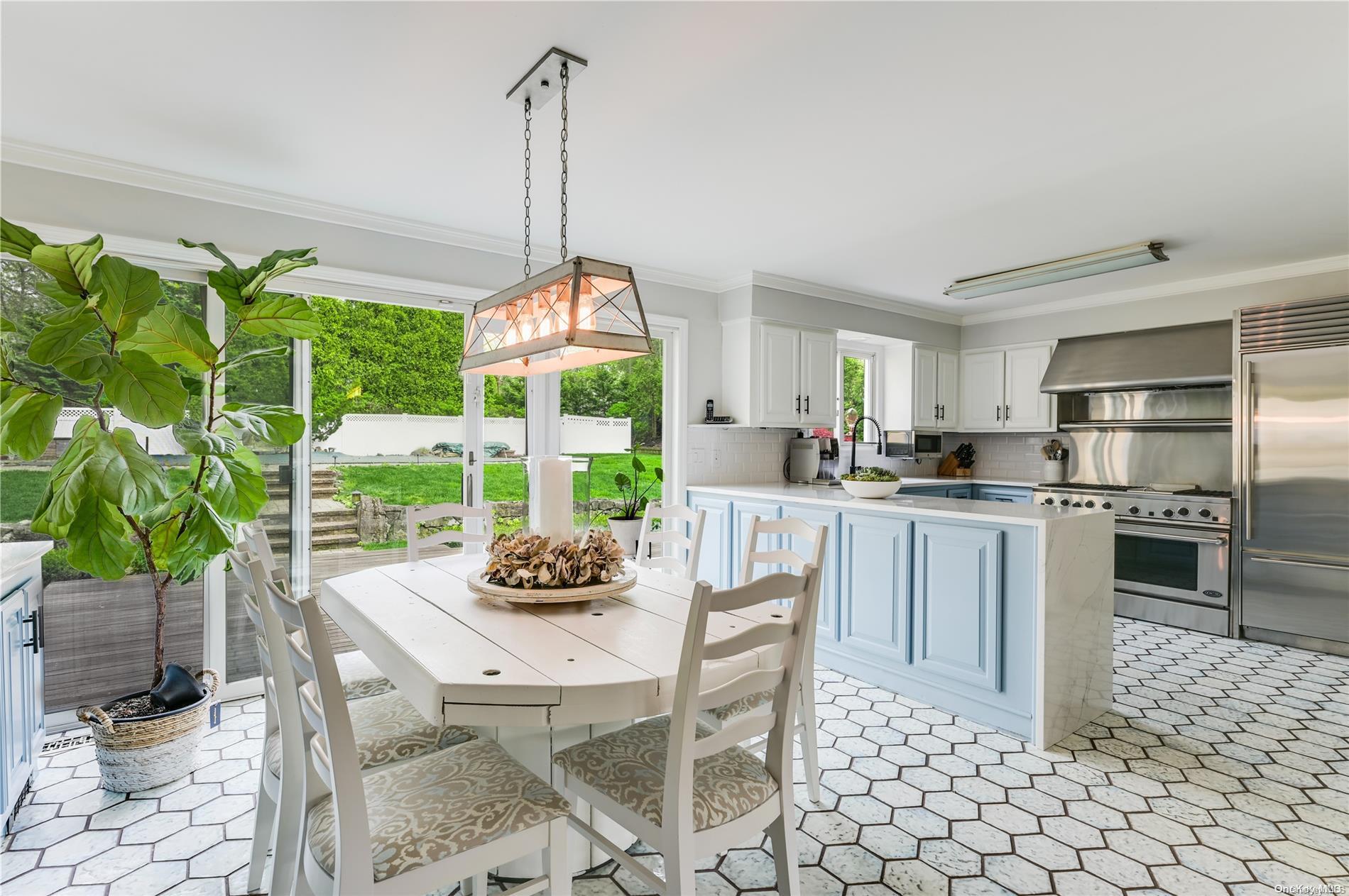 355 Windjammer Drive Southold, NY 11971 - Photo 6 of 21 a kitchen with stainless steel appliances kitchen island granite countertop a table and chairs in it