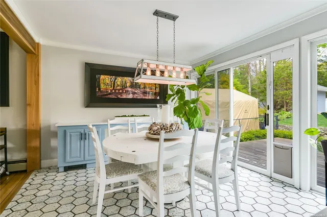 a view of a dining room with furniture wooden floor and a chandelier