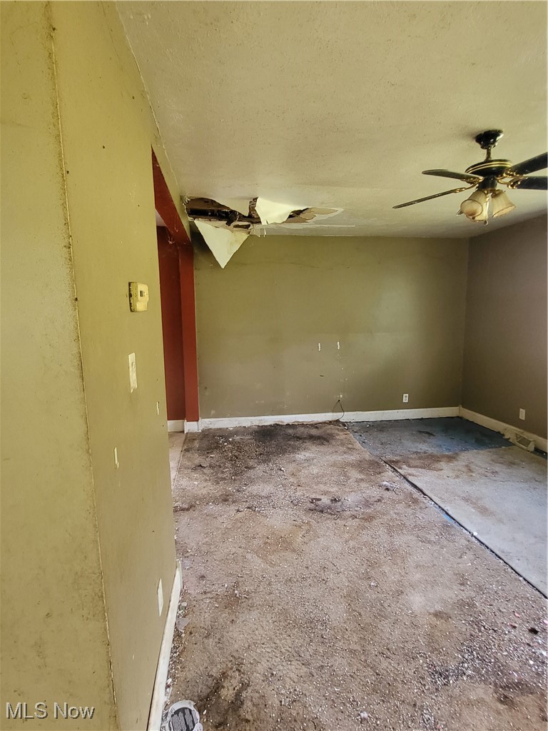 43650 Lafferty Oco Road Flushing, OH 43977 - Photo 9 of 23 Empty room featuring a textured ceiling and ceiling fan