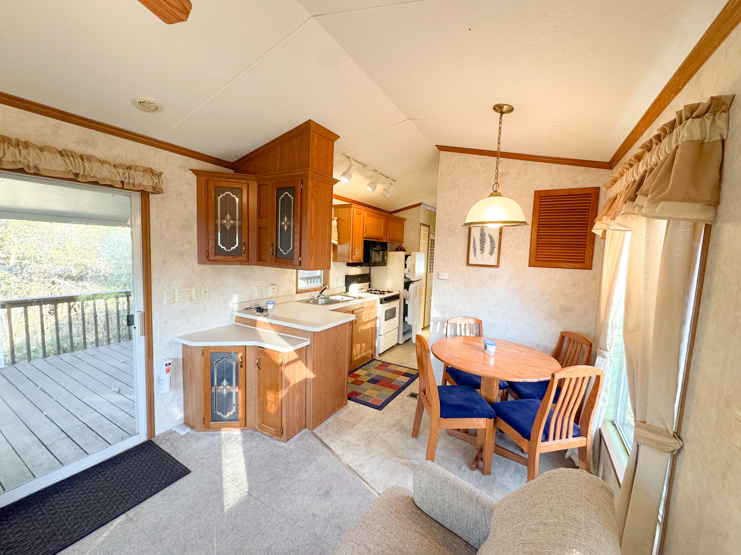 29-7 Woodhaven Sublette, IL 61367 - Photo 11 of 22 a dining room with stainless steel appliances kitchen island granite countertop furniture and a wooden floor