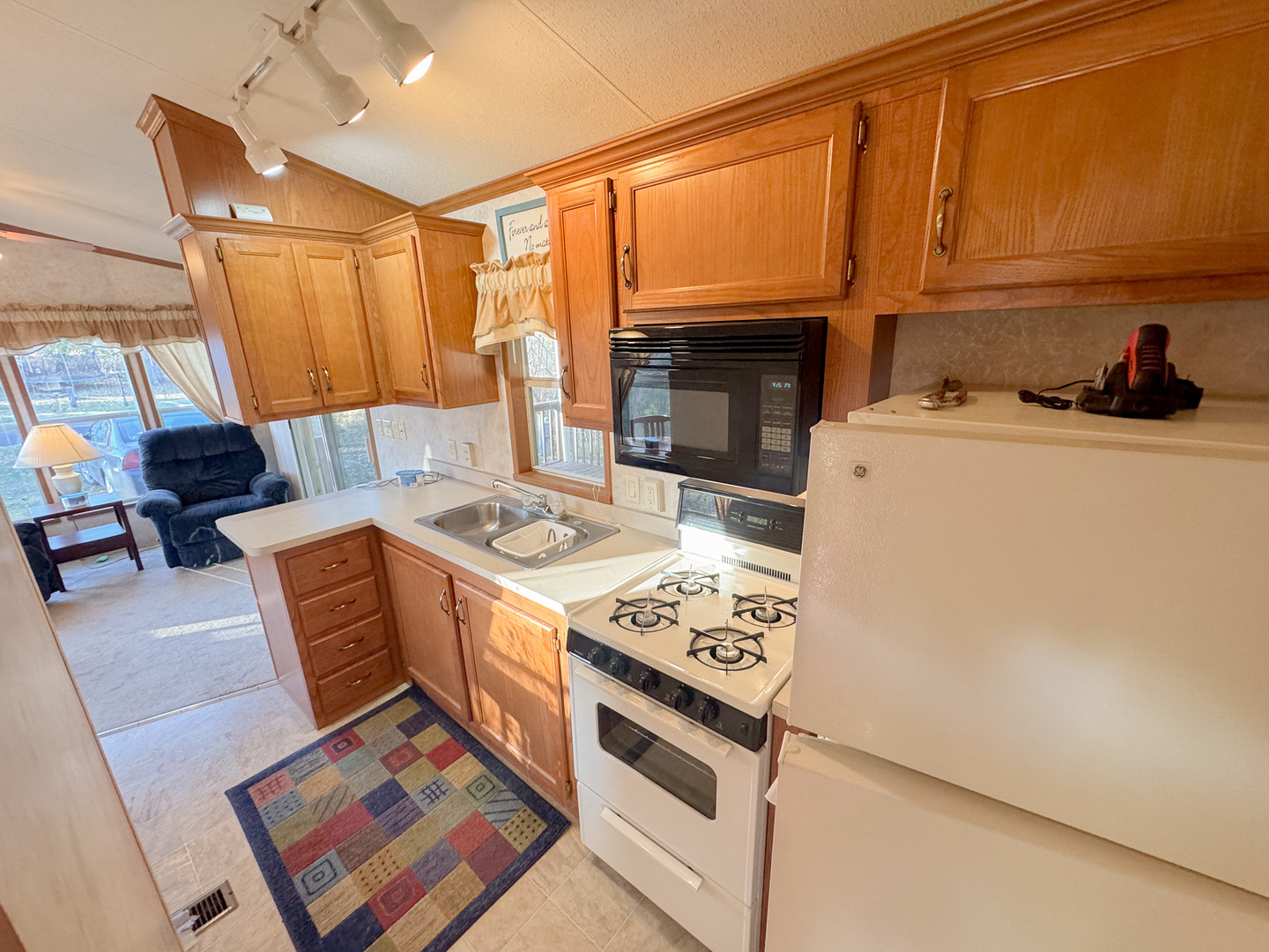 29-7 Woodhaven Sublette, IL 61367 - Photo 14 of 22 a kitchen with stainless steel appliances granite countertop a stove a sink dishwasher and a microwave with granite countertops