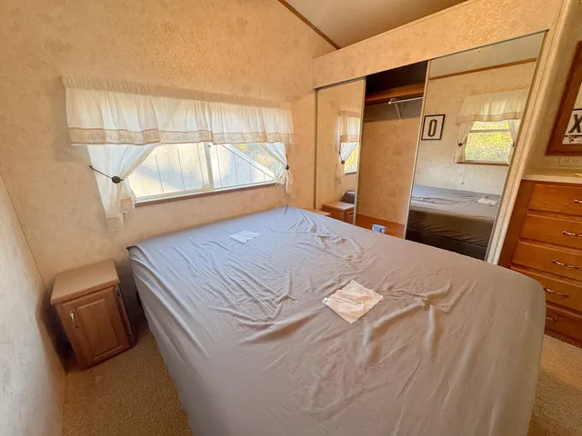 a bedroom with a bed and a mirror