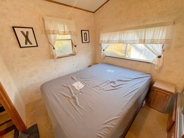 a bedroom with a bed and a window