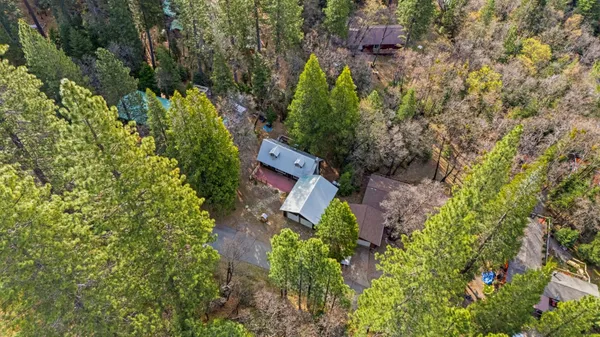 an aerial view of a house with a yard
