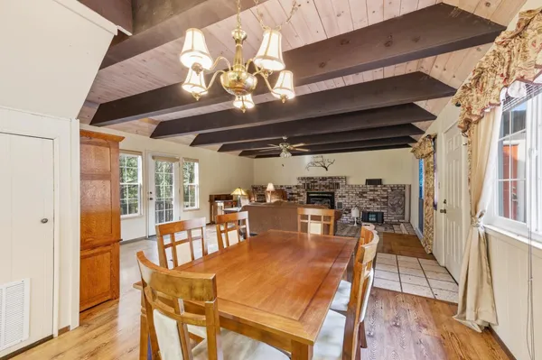 a view of a dining room with furniture wooden floor and chandelier
