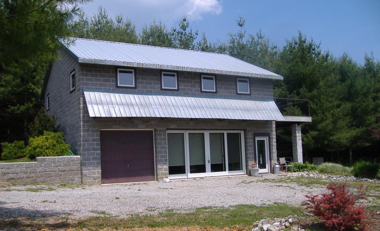 740 Dusty Rock Road Northwest Riner, VA 24149 - Photo 1 of 16 a front view of a house with a garden and trees