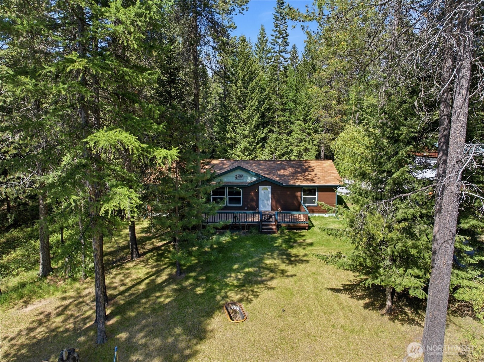 1142 Driskill Road Newport, WA 99156 - Photo 6 of 40 a view of a barn in the middle of a forest