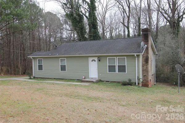 a view of a house with a yard and garage