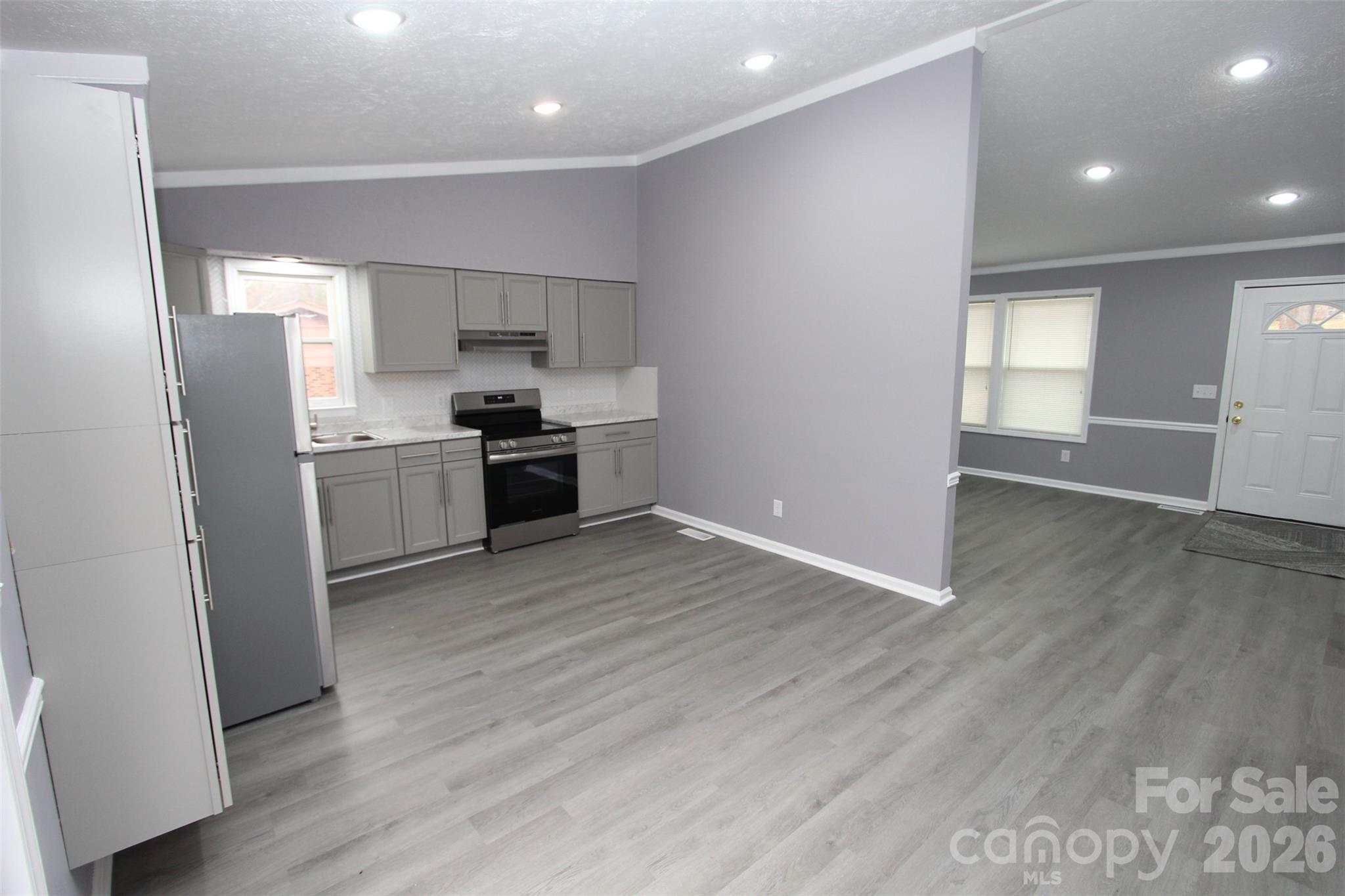 48 Piper Road Wadesboro, NC 28170 - Photo 11 of 34 a kitchen with stainless steel appliances granite countertop a refrigerator a sink dishwasher a stove with wooden floors and cabinets