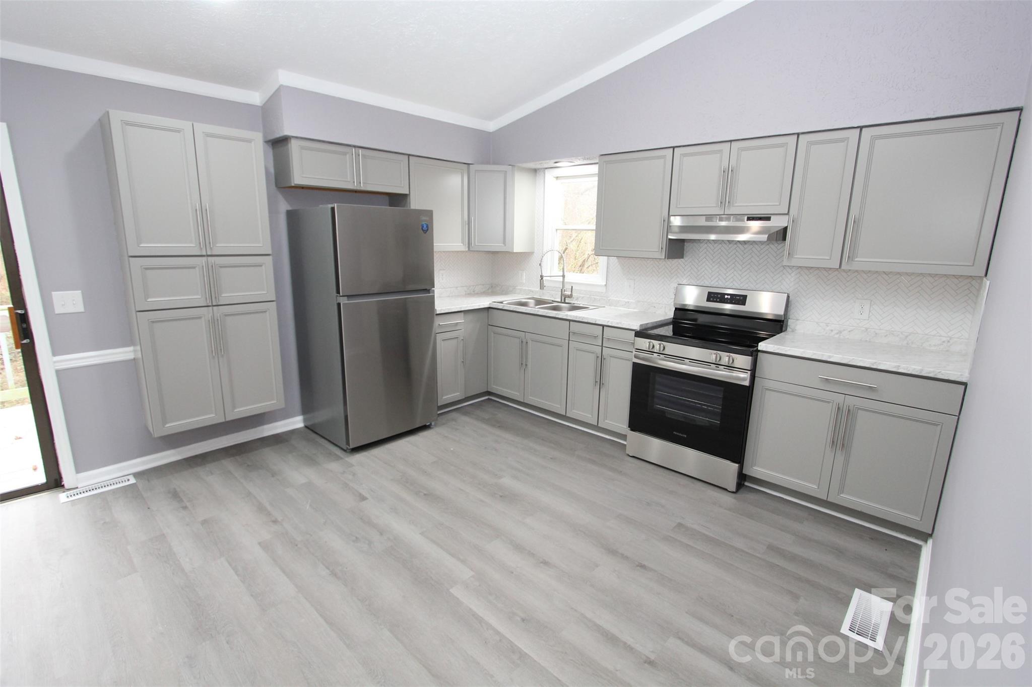 48 Piper Road Wadesboro, NC 28170 - Photo 12 of 34 a kitchen with a refrigerator a stove top oven and cabinets