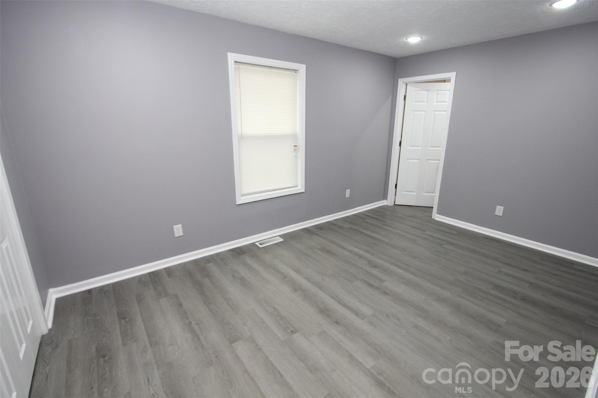 48 Piper Road Wadesboro, NC 28170 - Photo 17 of 34 an empty room with wooden floor and windows