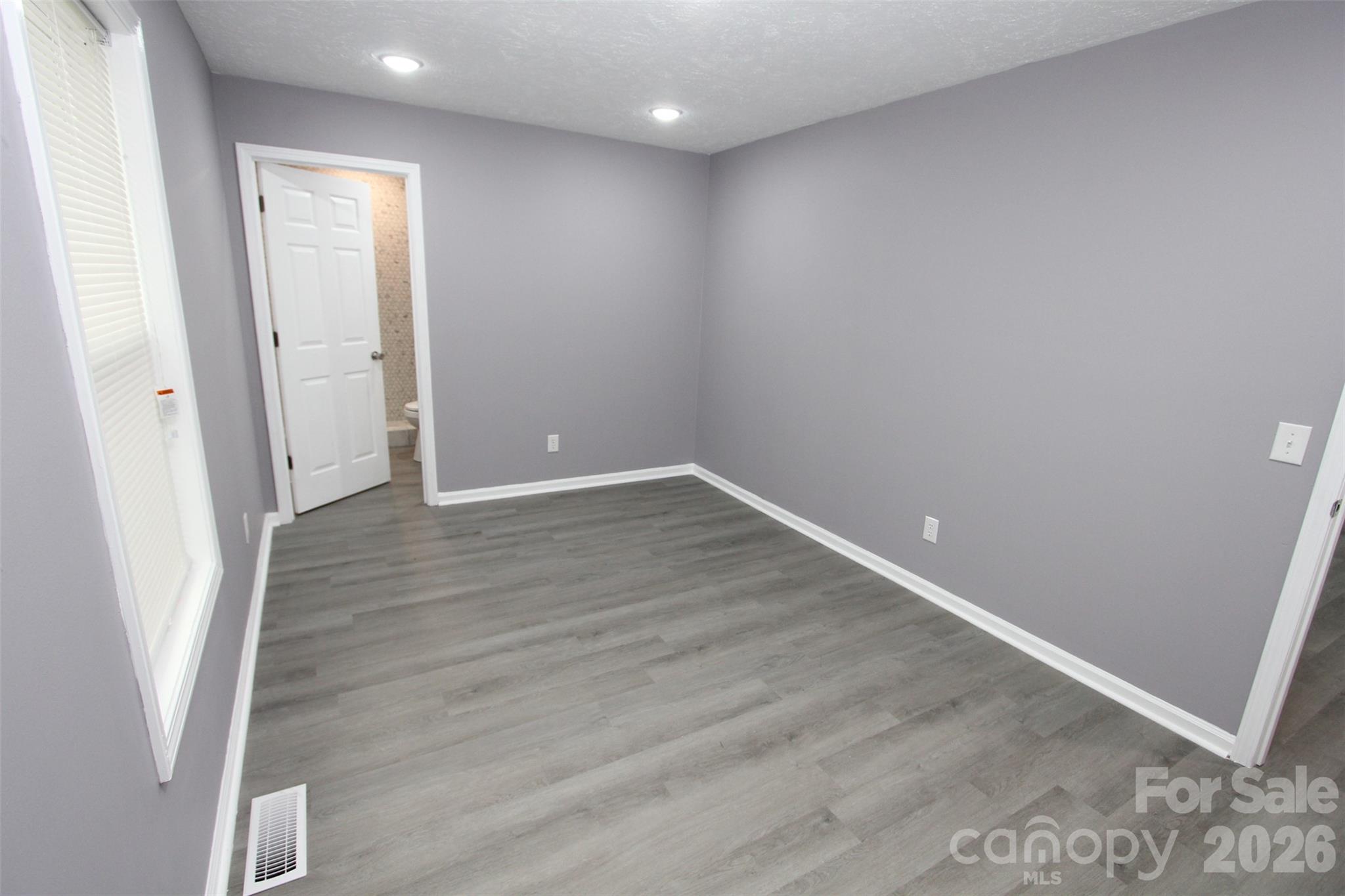 48 Piper Road Wadesboro, NC 28170 - Photo 19 of 34 an empty room with wooden floor and windows
