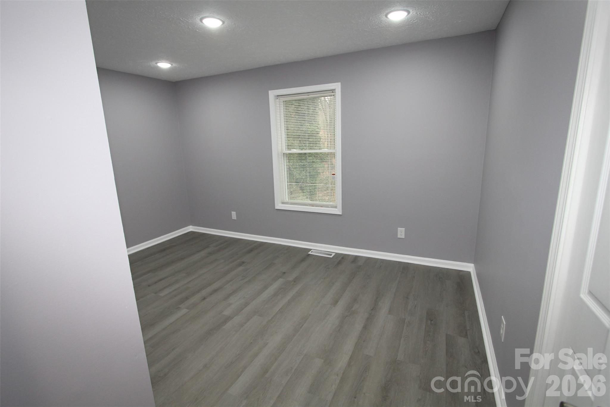 48 Piper Road Wadesboro, NC 28170 - Photo 23 of 34 an empty room with wooden floor and windows