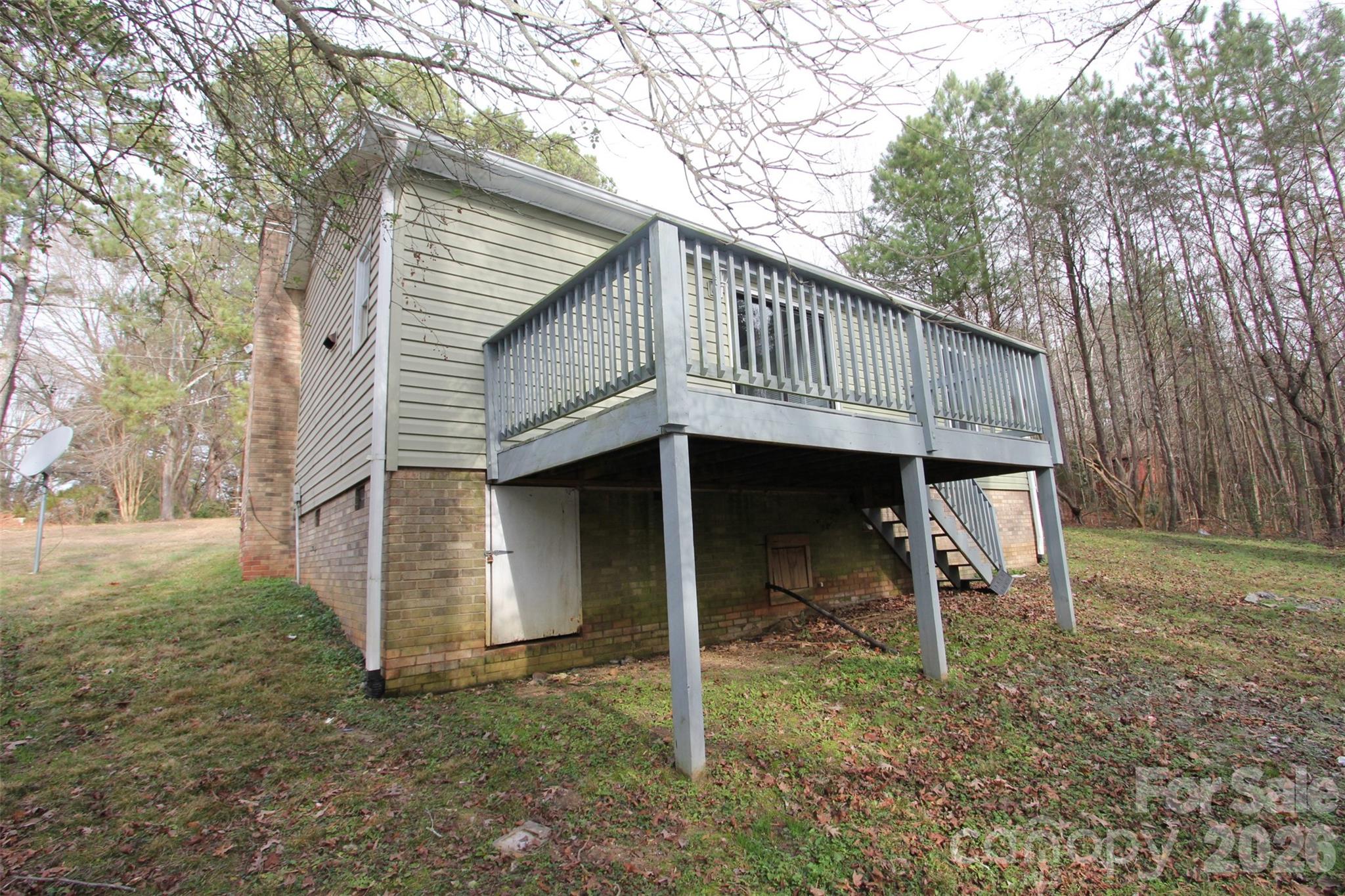 48 Piper Road Wadesboro, NC 28170 - Photo 32 of 34 a view of a small house with a deck and a yard