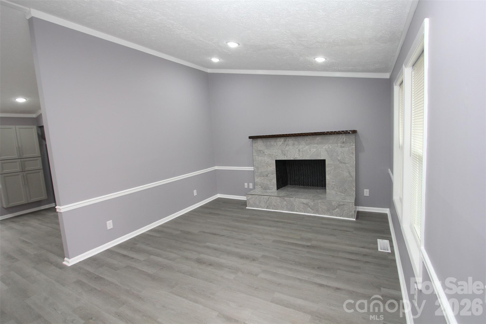 48 Piper Road Wadesboro, NC 28170 - Photo 6 of 34 a view of an empty room with wooden floor and a window