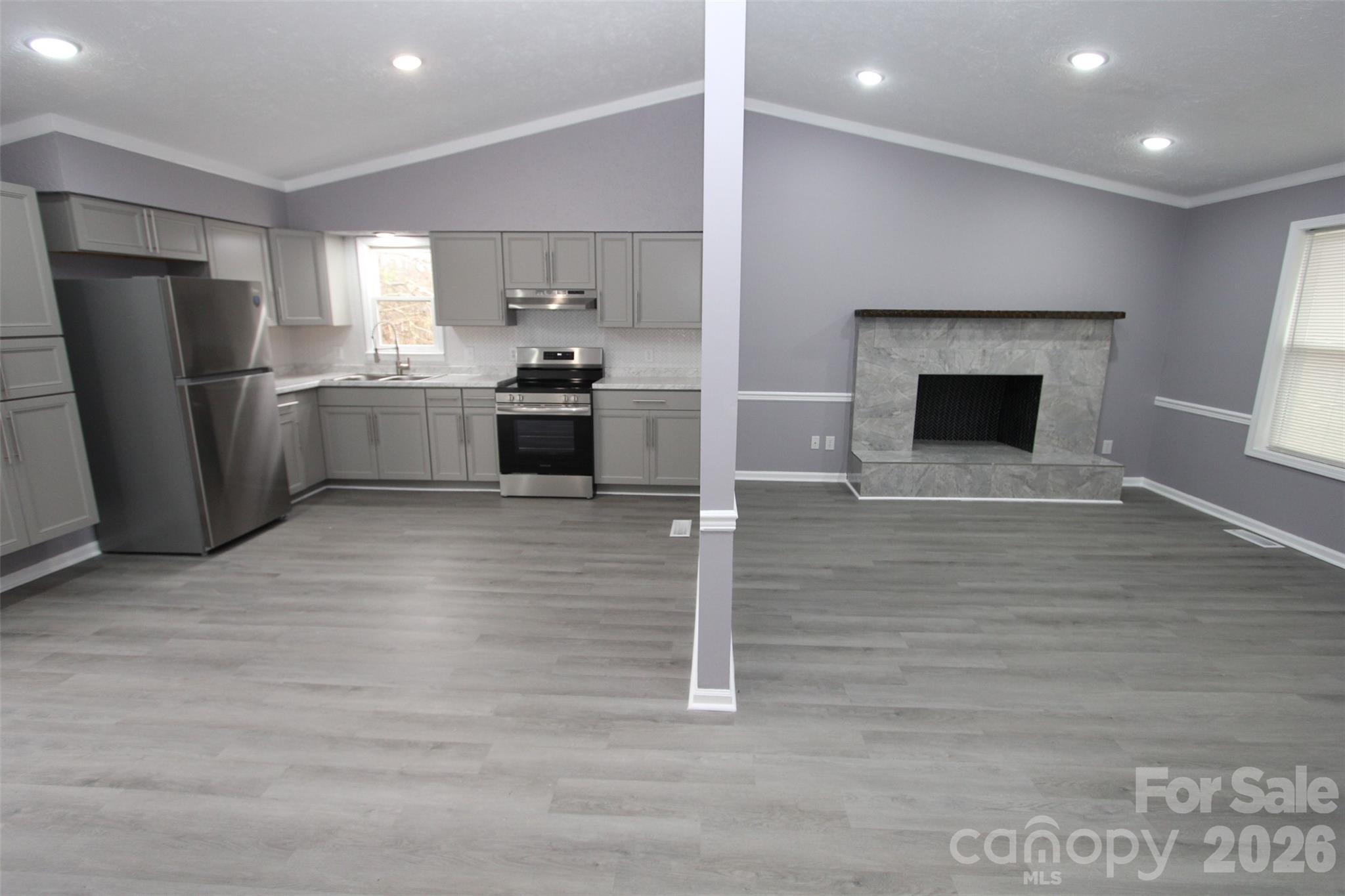 48 Piper Road Wadesboro, NC 28170 - Photo 9 of 34 a large kitchen with stainless steel appliances wooden floor and a refrigerator