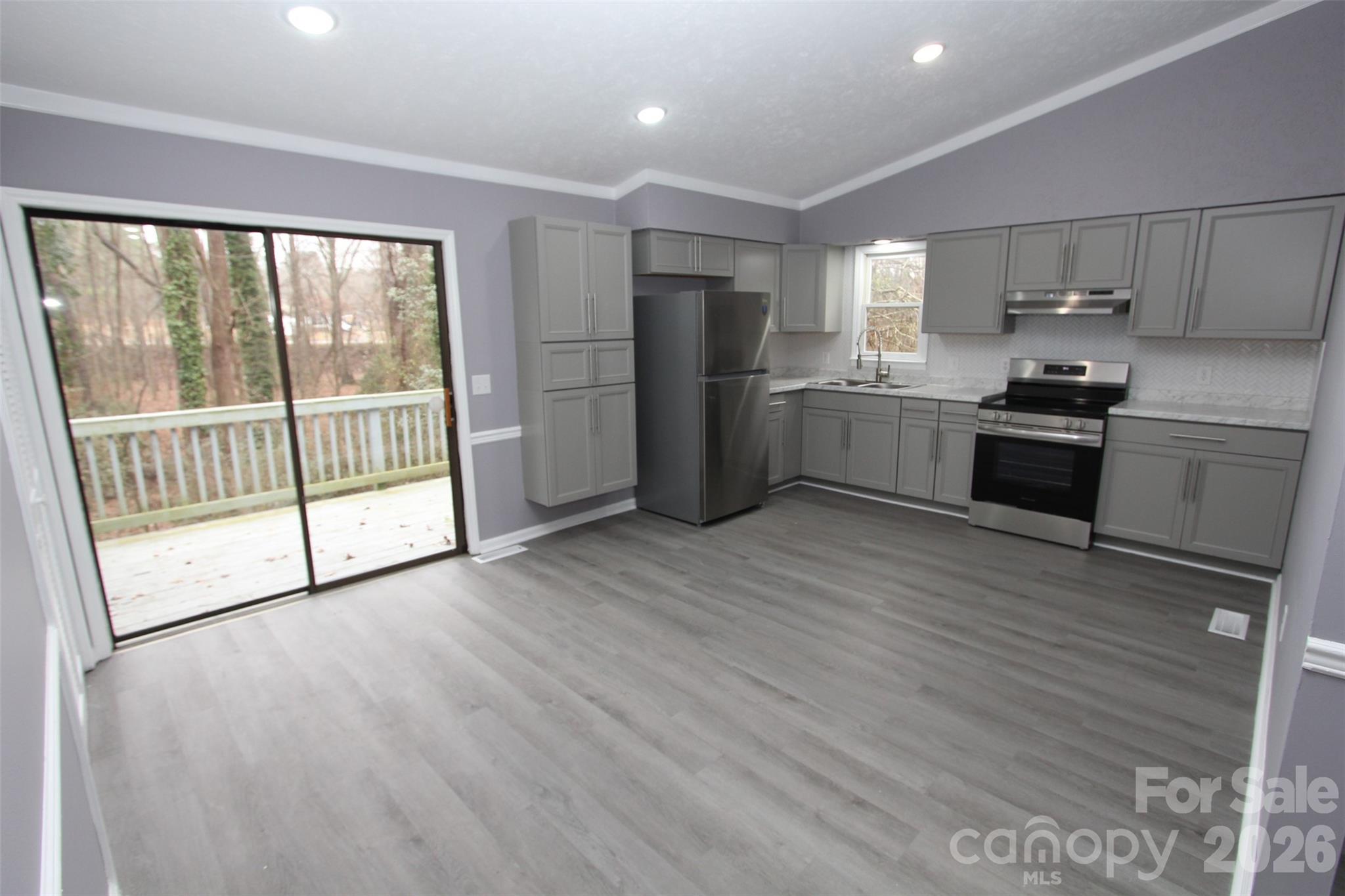 48 Piper Road Wadesboro, NC 28170 - Photo 10 of 34 a kitchen with stainless steel appliances granite countertop a refrigerator a sink a stove and white cabinets with wooden floor