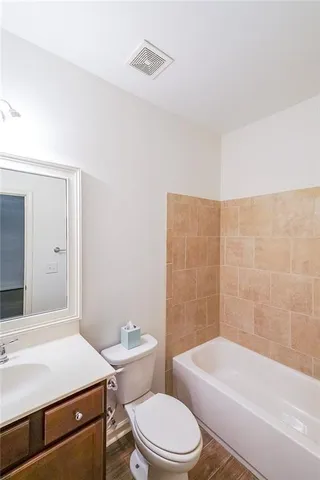 a bathroom with a toilet a sink and bathtub