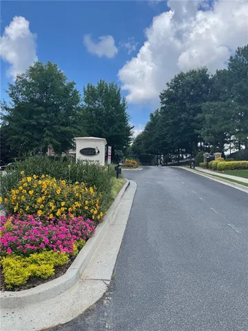 a view of a garden with flowers and trees