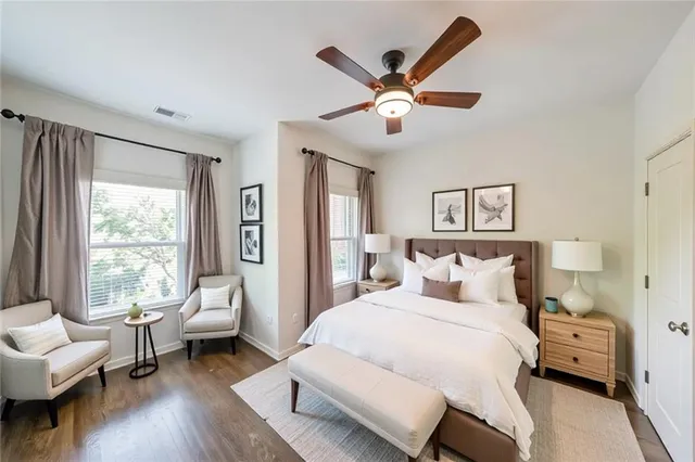 a bedroom with a bed and a large window