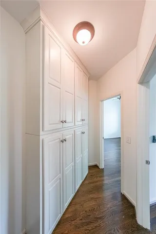 a view of a hallway with wooden floor